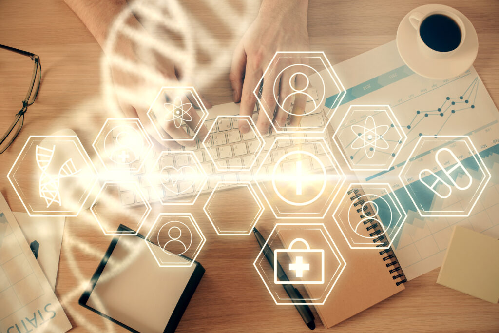 Double exposure of man's hands typing over computer keyboard and DNA hologram drawing. Top view. Medical education concept.