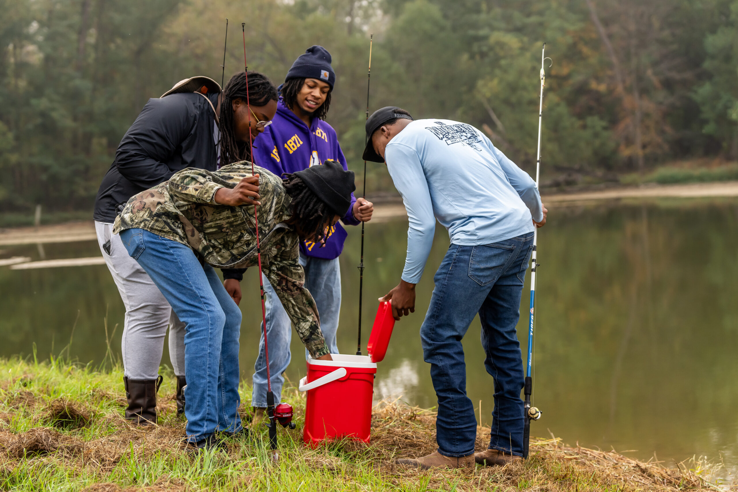 A group of four Alcorn State University students placing items in a cooler.