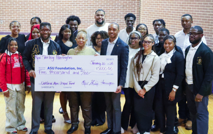 Rev. Harrington presents a $5,000 donation to Alcorn and is pictured with University staffers and the ASU Gospel Choir.