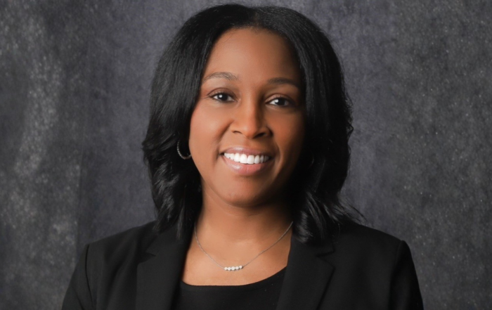 Dr. Tracey Gregory, Dean of the School of Education & Psychology at Alcorn State University, poses for a professional headshot against a gray background wearing a black blazer and silver necklace.