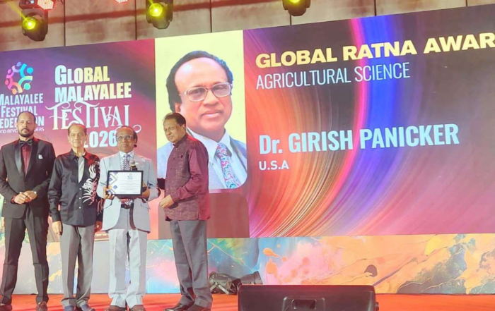 Dr. Girish Kumar Panicker accepts the 2026 Global Ratna Award for Agricultural Science on stage at the Global Malayalee Festival in Kochi, India.