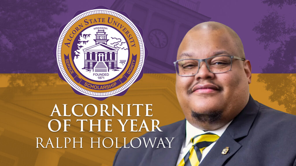 Ralph Holloway, recipient of the Alcorn State University 2026 Alcornite of the Year award, poses in a dark suit and striped tie against a purple and gold graphic background featuring the Alcorn State University seal and the Old Camelia Hall clock tower.
