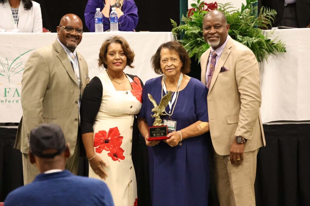 Zelmarine Anderson Murphy holds the Spirit of Courage Award with Dr. Dexter Wakefield, Darnella Winston and President Tracy Cook at the Small Farmers Conference.