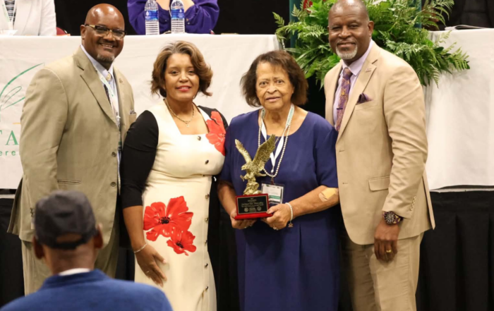 Zelmarine Anderson Murphy holds the Spirit of Courage Award with Dr. Dexter Wakefield, Darnella Winston and President Tracy Cook at the Small Farmers Conference.